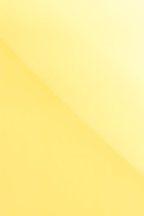 Abstract background of bright yellow colored surface composed with gradient and different tones of color