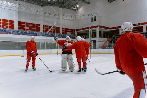 Group of Men Playing Ice Hockey