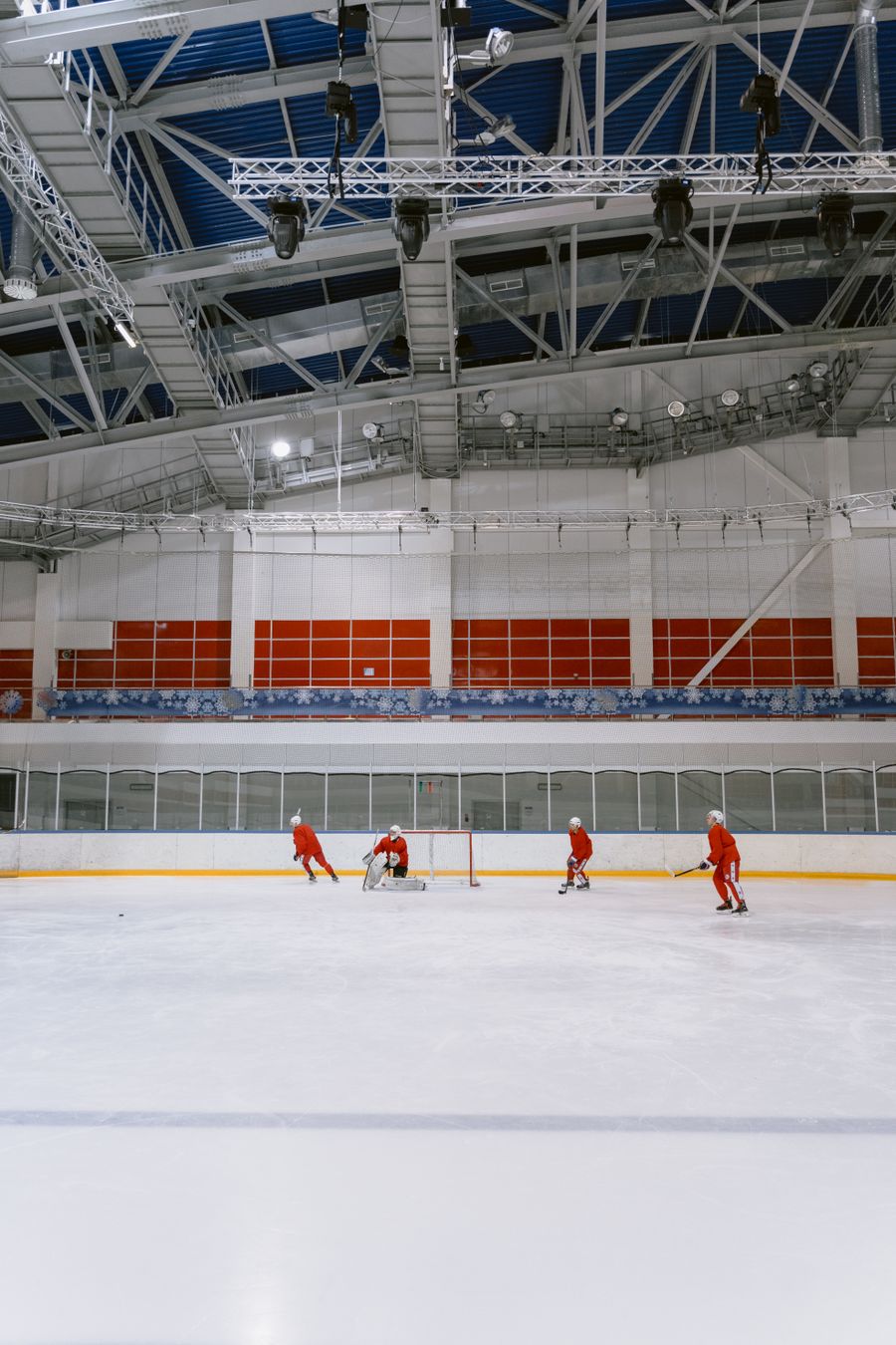 Squad running a passing drill under arena lights