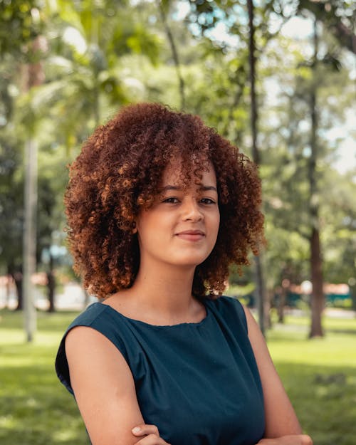 Free Woman in Blue Top Standing Near Green Trees Stock Photo