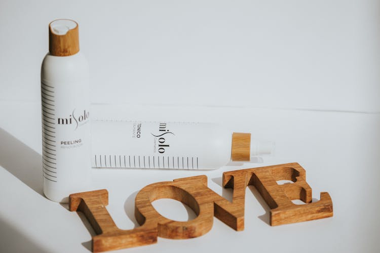 Bottles Of Misolo Skin Care Products Next To Wooden Love Sign