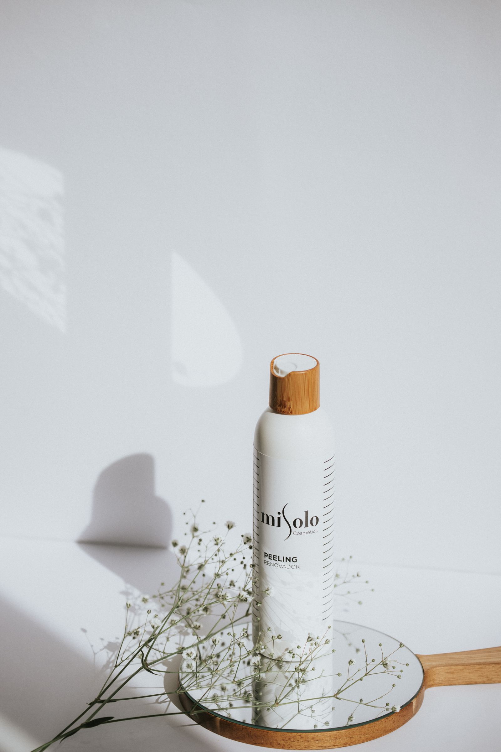 Cosmetic bottle resting on a hand mirror.