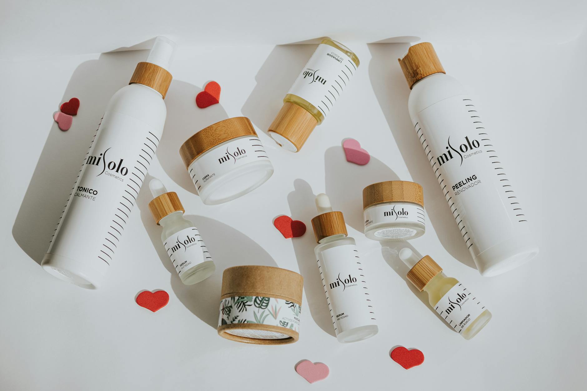Flat lay of eco-friendly cosmetic products with playful heart accents.
