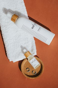 Aesthetic display of beauty products with spa essentials against a warm brown backdrop.