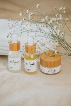 Natural skincare products displayed with delicate flowers, emphasizing organic beauty and elegance.