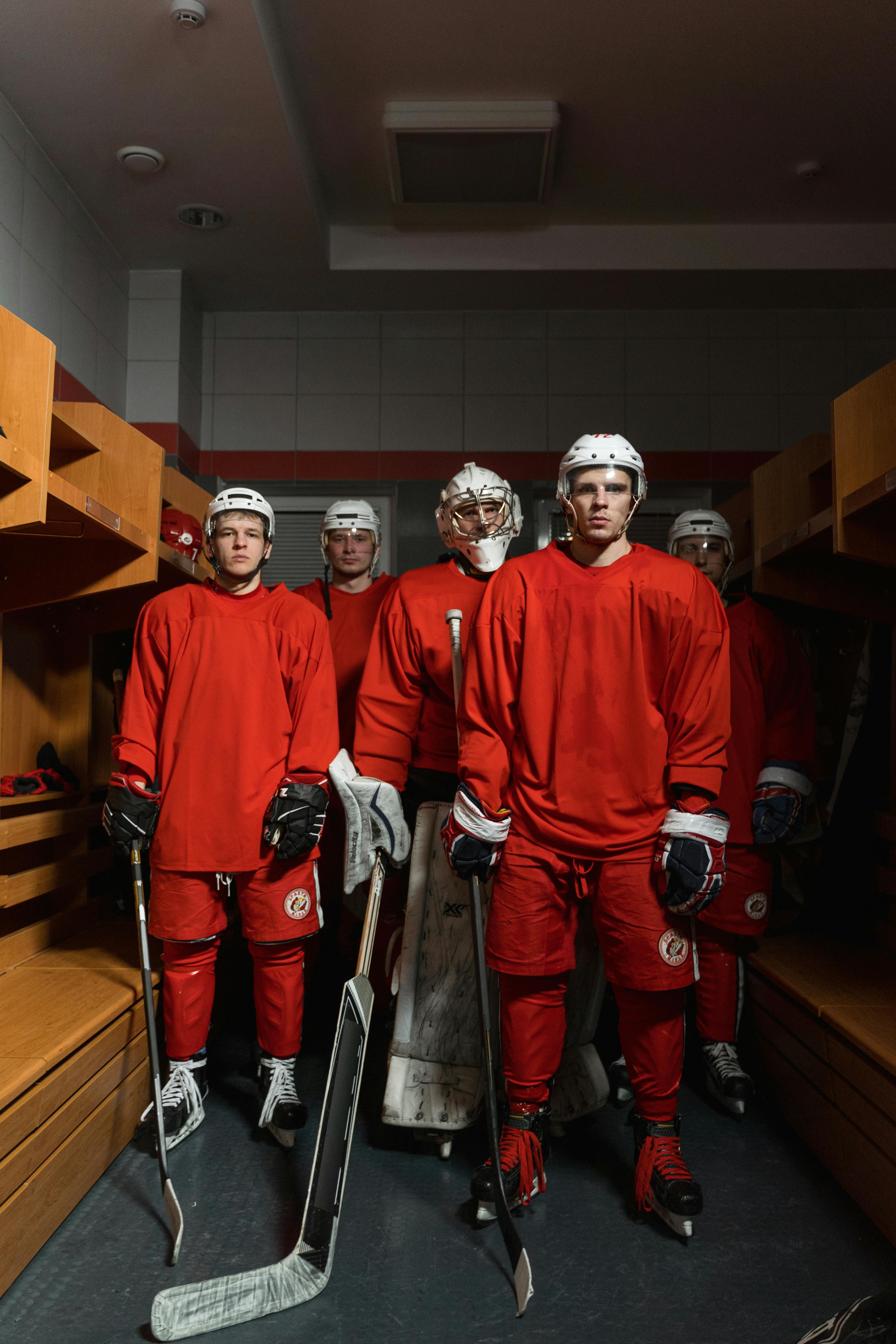 group of men wearing hockey gear