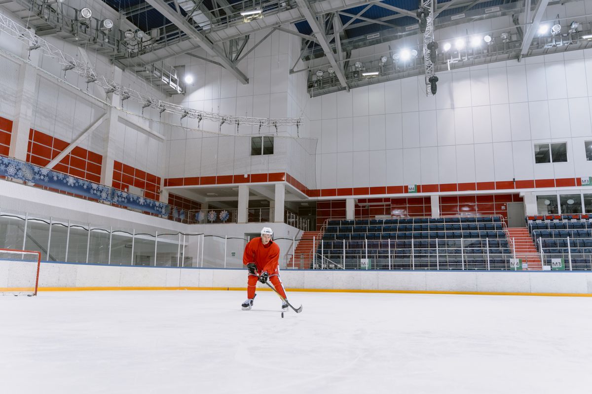 Hockey player skating on an indoor ice rink