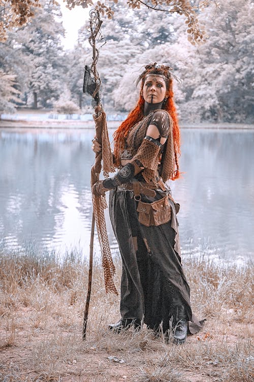 Free Woman in Medieval Costume Holding Brown Stick Stock Photo