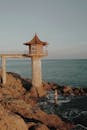 Lighthouse on a Cement Pillar by a Sea