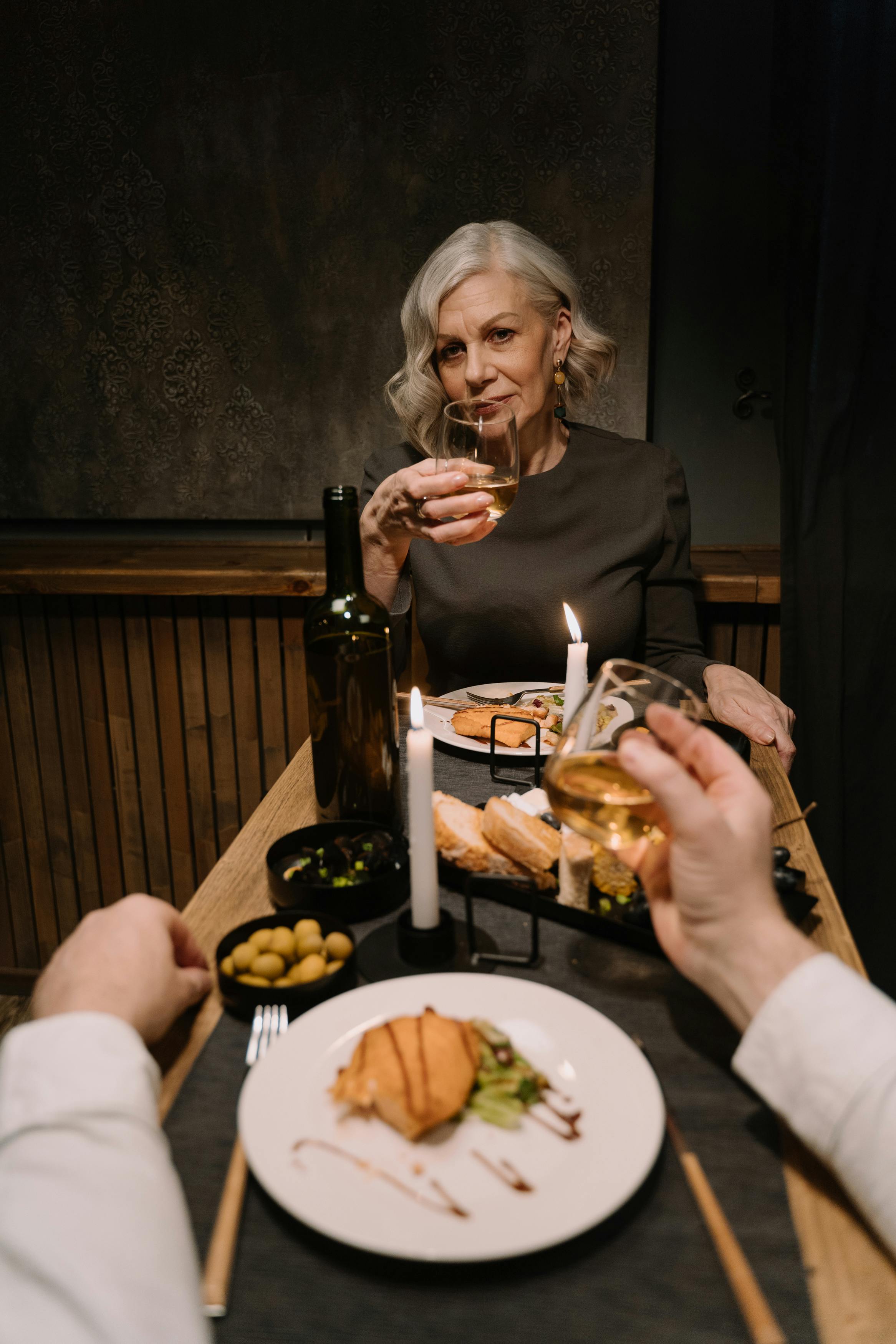 woman in gray sweater eating