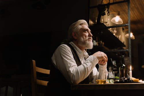 An Elderly Man Having Dinner