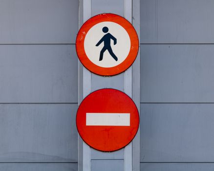Close-up of pedestrian and no entry signs in Granada, Spain.