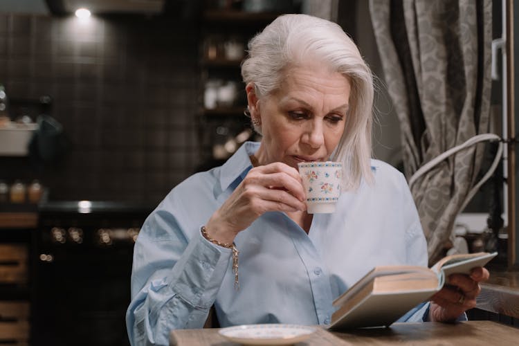 An Elderly Woman Reading A Book 