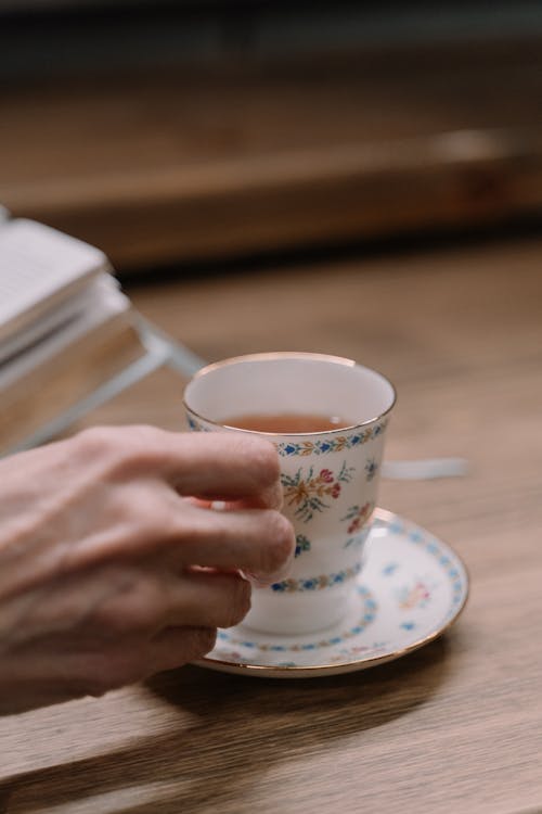 Close-Up Shot of a Person Holding a Cup of Tea