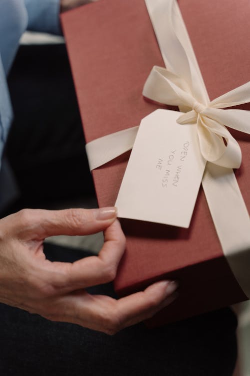 A Box of Gift with a Card and White Ribbon