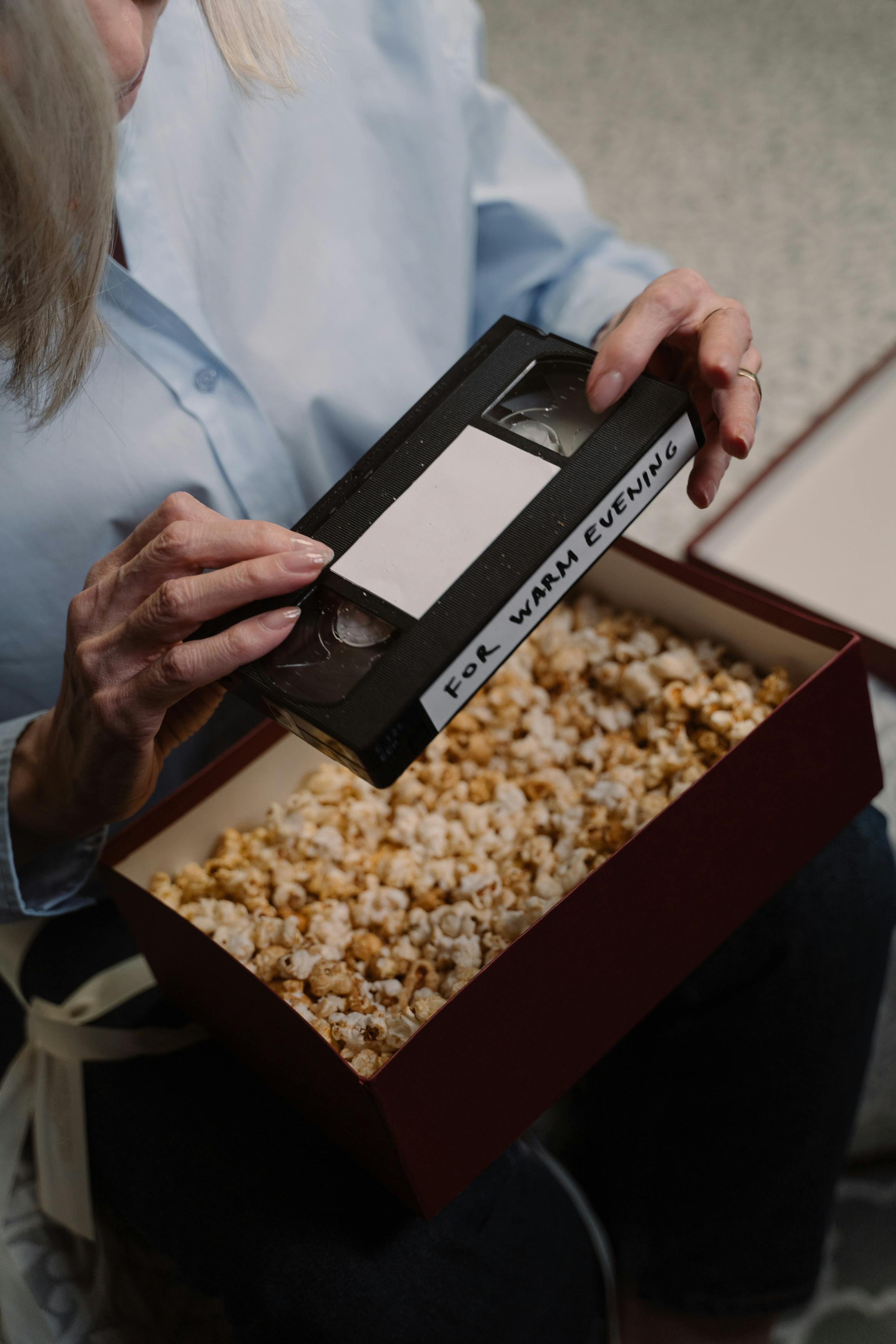 a woman holding vhs a video tape