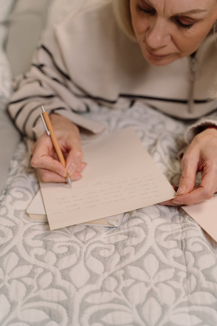 Adult Woman Writing On A Paper