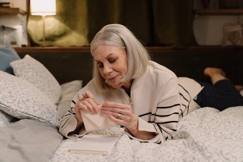 An Elderly Woman Holding an Envelope