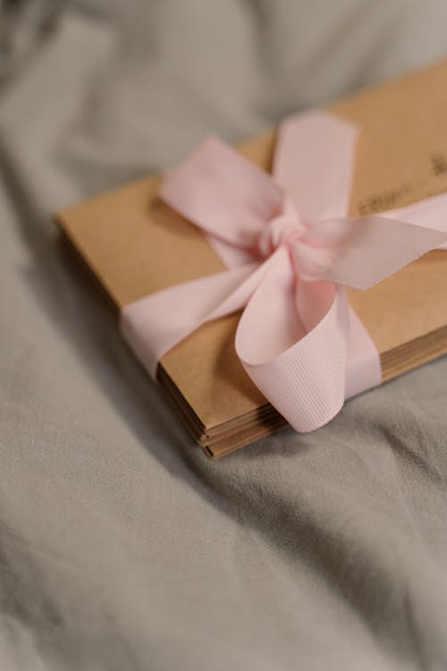 Free Close-Up Shot of Postcards Wrapped in a Pink Ribbon Stock Photo