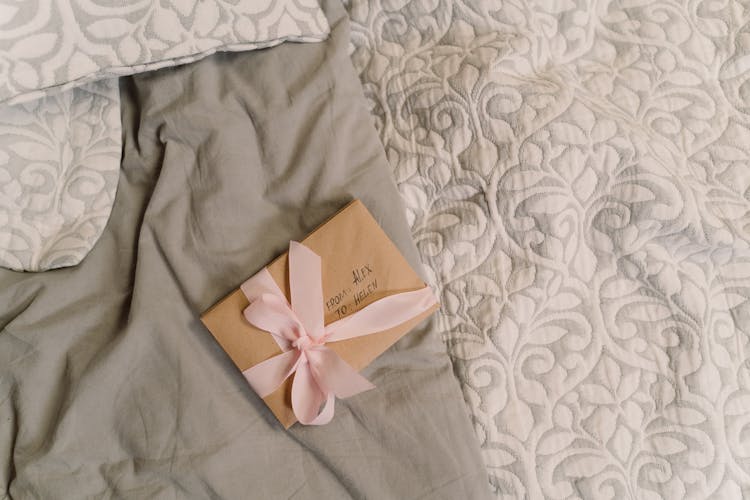 Close-Up Shot Of Postcards Wrapped In A Pink Ribbon