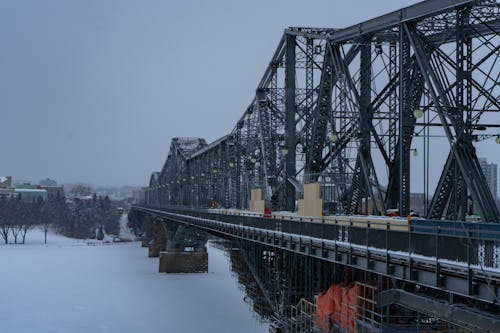  Metal Bridge over a Body of Water Covered with Snow