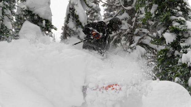A skier navigates through deep powdered snow in Revelstoke, BC, during winter.