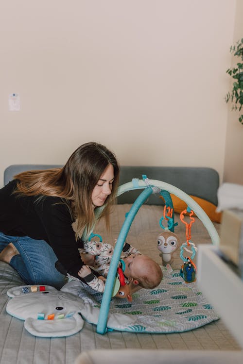 Free A Mother Putting Down Her Baby Stock Photo