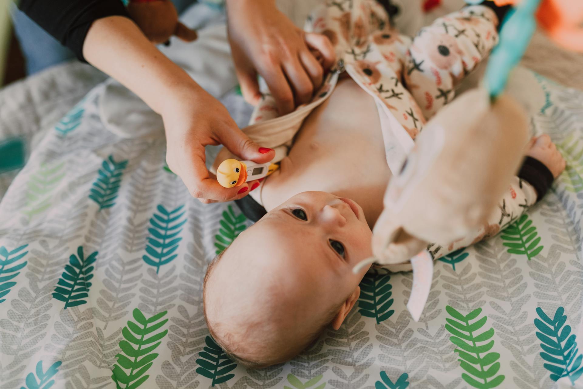 Person Checking the Baby's Temperature