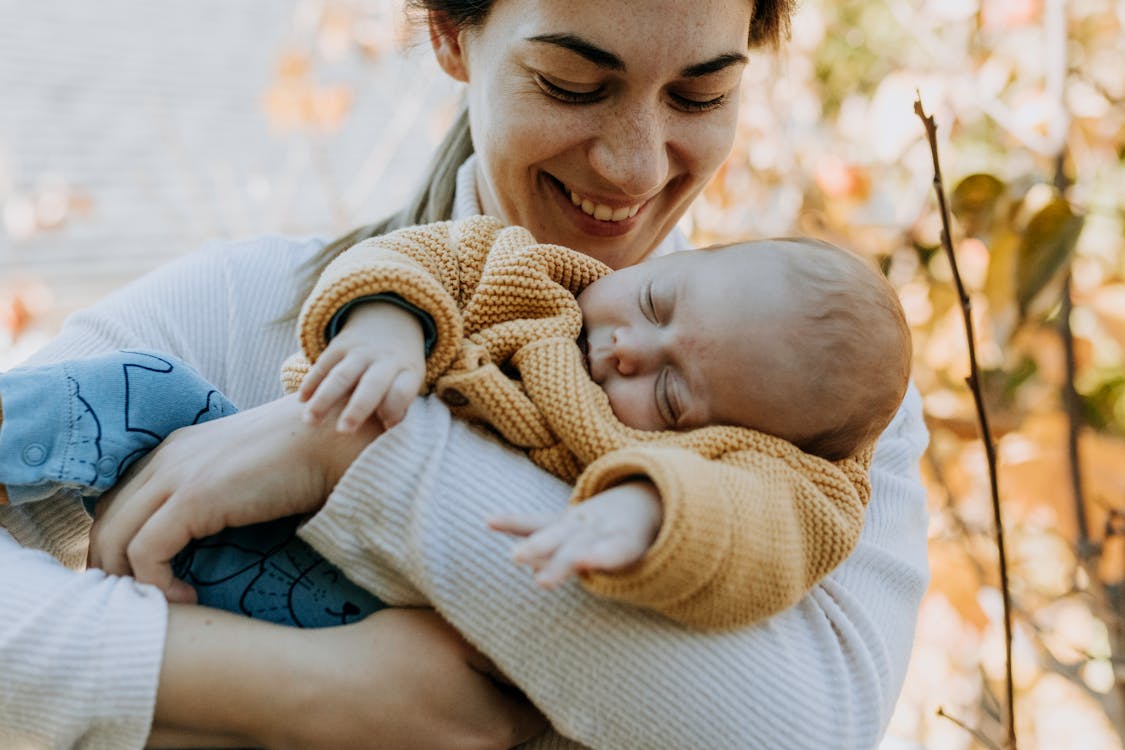 Man in White Shirt Carrying Baby