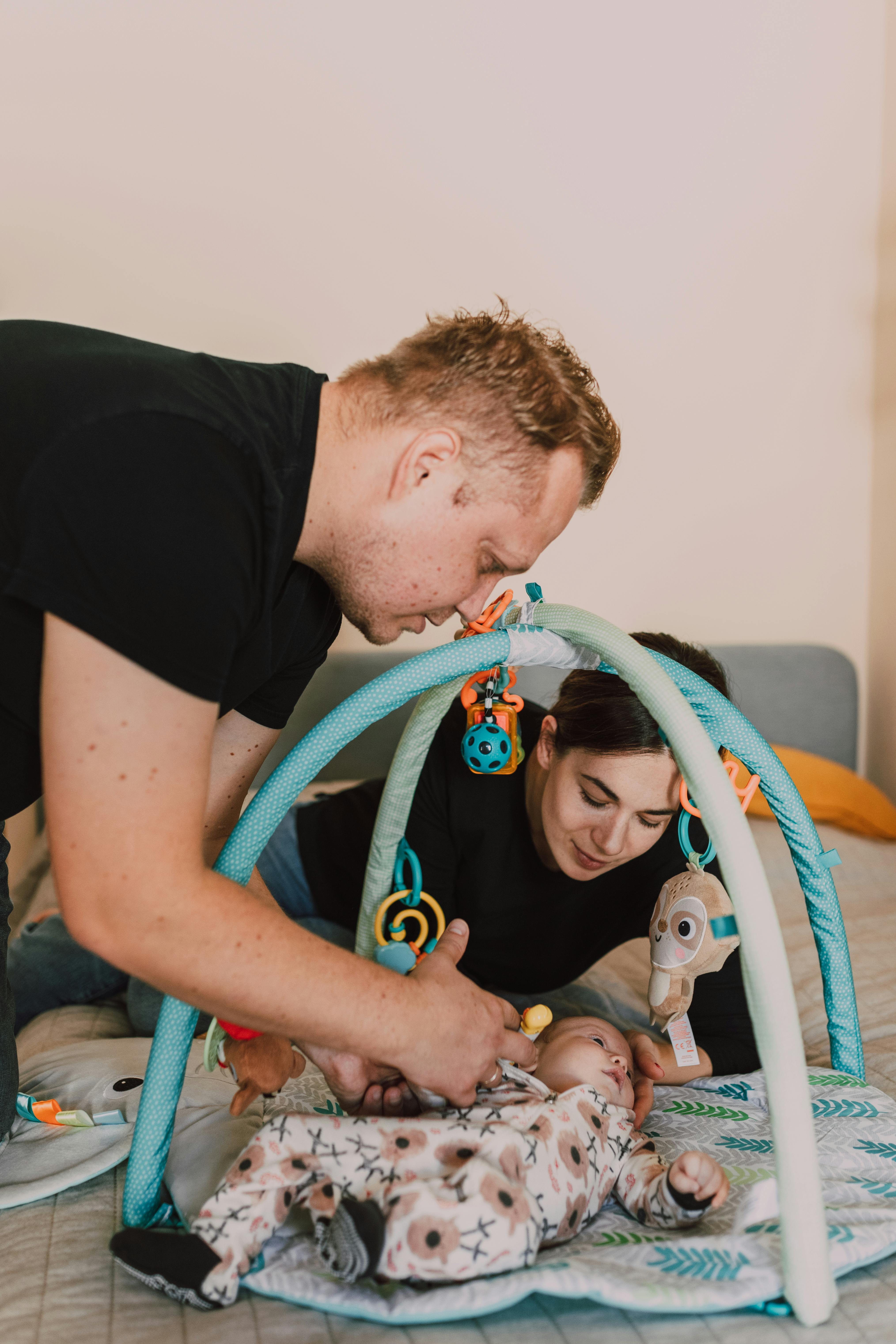 a mother and father taking care of their baby