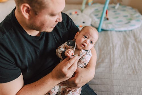 Free A Father Carrying His Baby Stock Photo