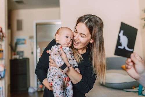 Adorable Baby Looking at the Baby Flash Card