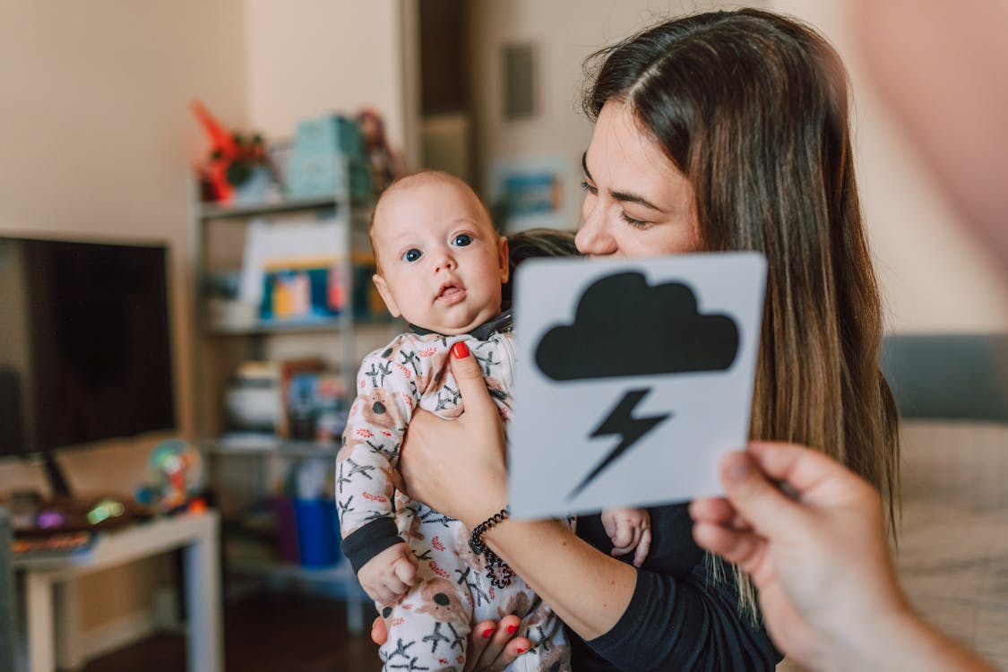 Person Showing Flash Card to the Baby