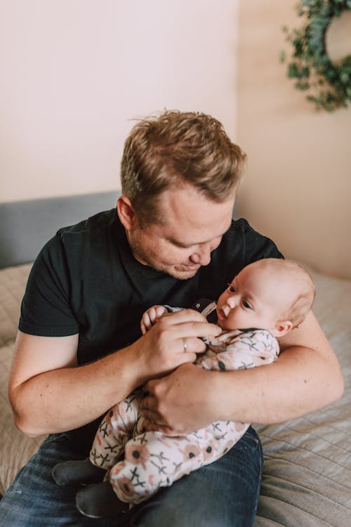 Free A Father Carrying His Baby Stock Photo