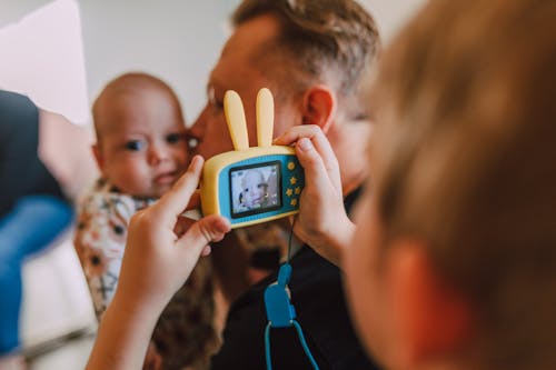 A Boy Taking Picture of a Baby