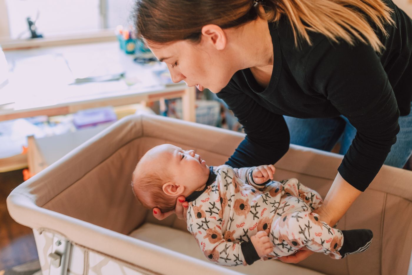 Mother caring for her baby in a softly lit home setting