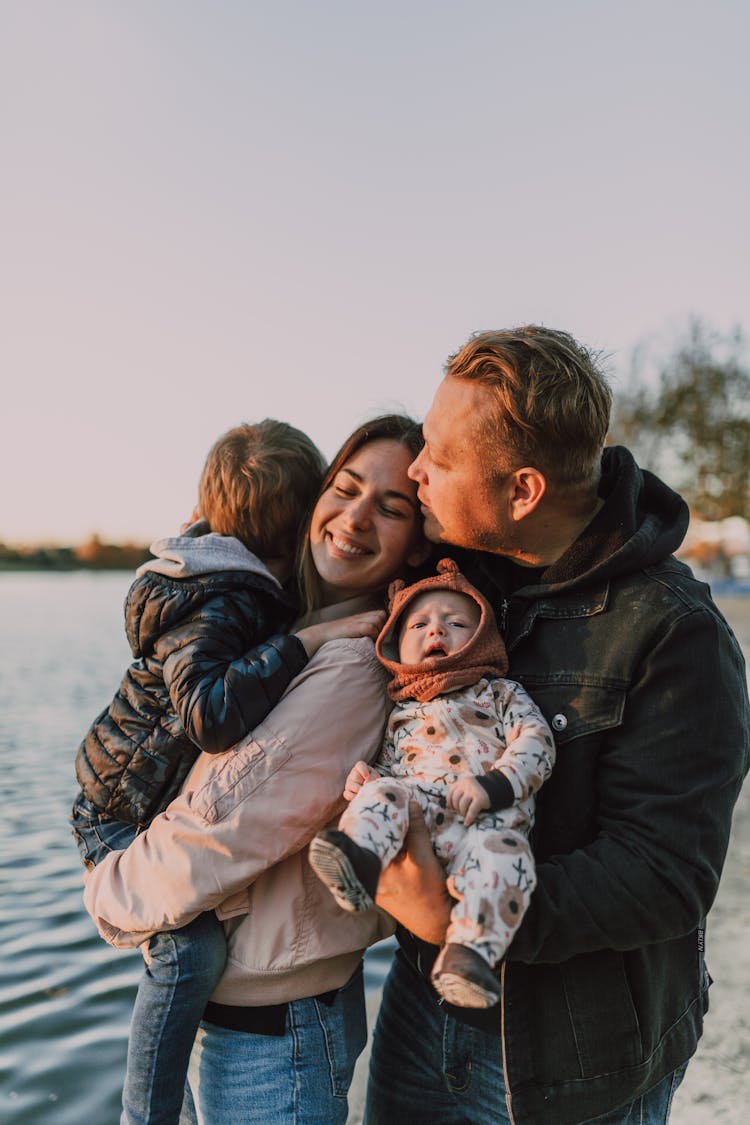 A Couple Carrying Their Kids