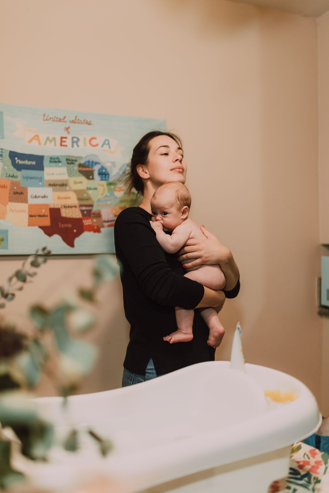 Parent gently bathing a baby during an everyday care routine