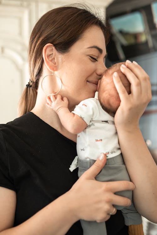 A Mother Kissing Her Baby