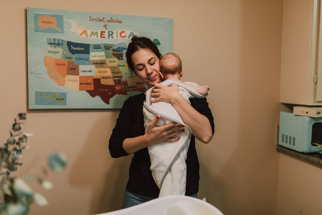 Free A Mother Carrying Her Newborn Baby Stock Photo