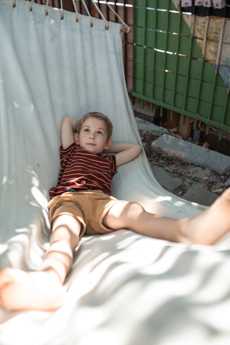 A Boy Resting In A Hammock