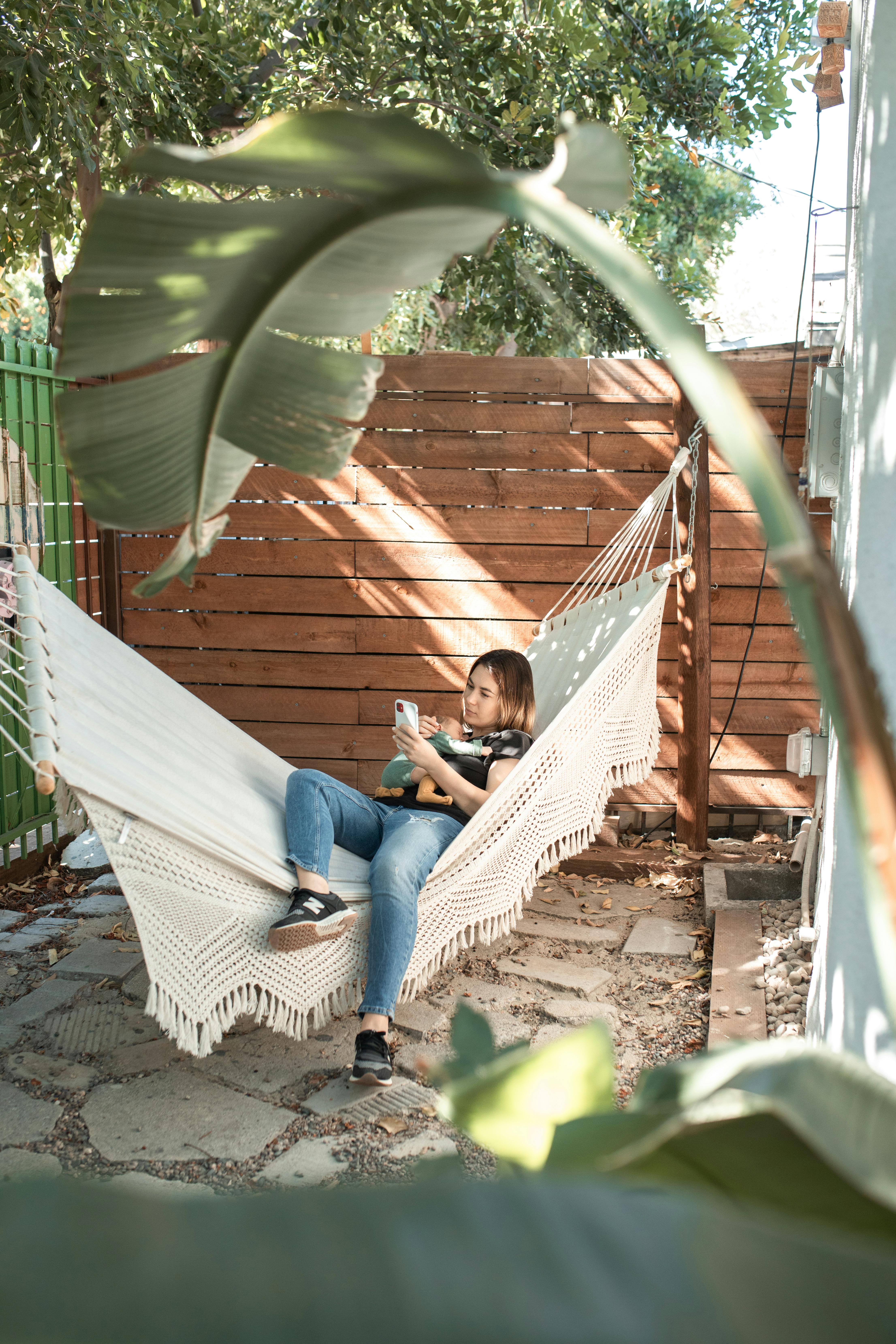 woman in blue denim jeans sitting on hammock