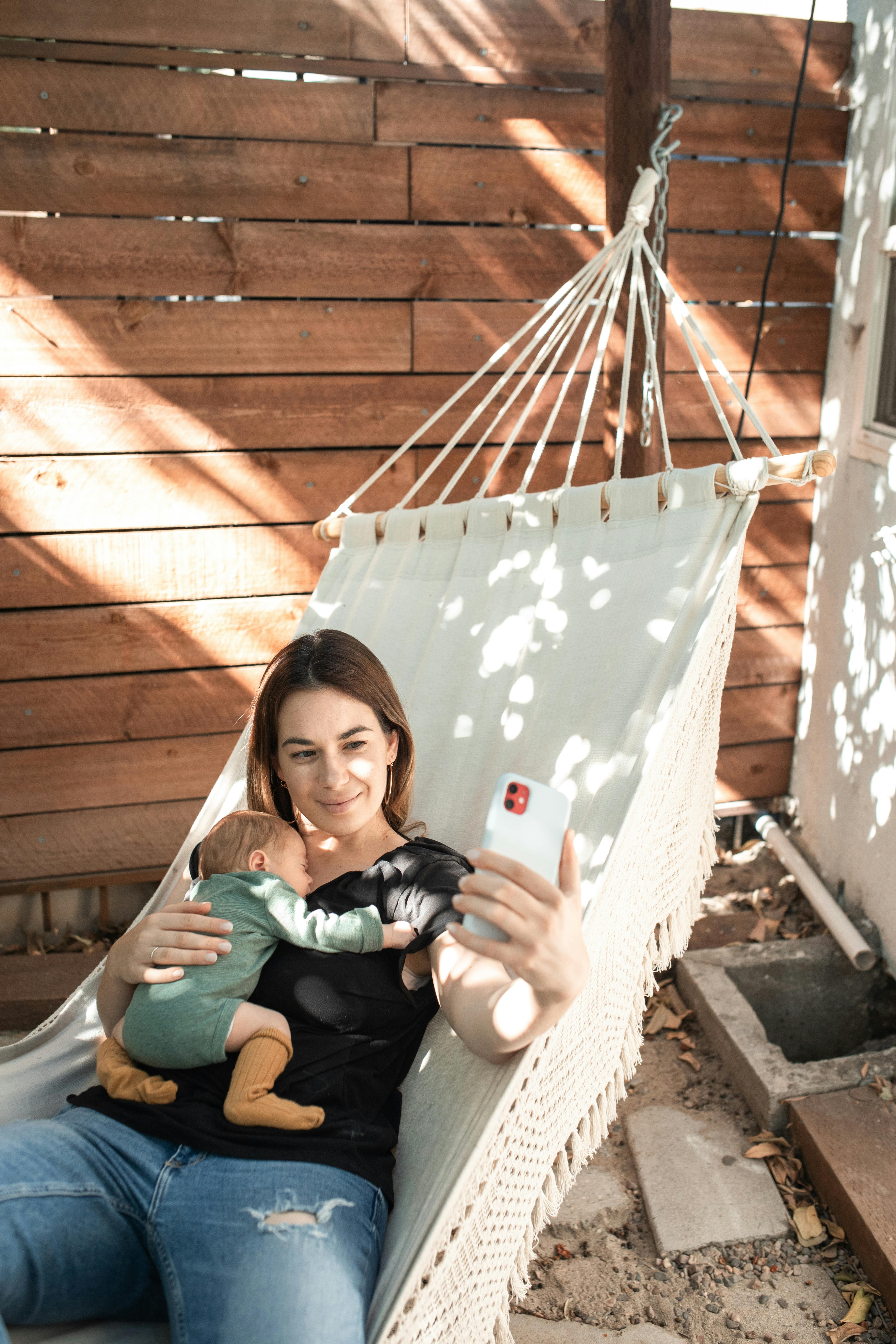 woman in green shirt sitting on white hammock