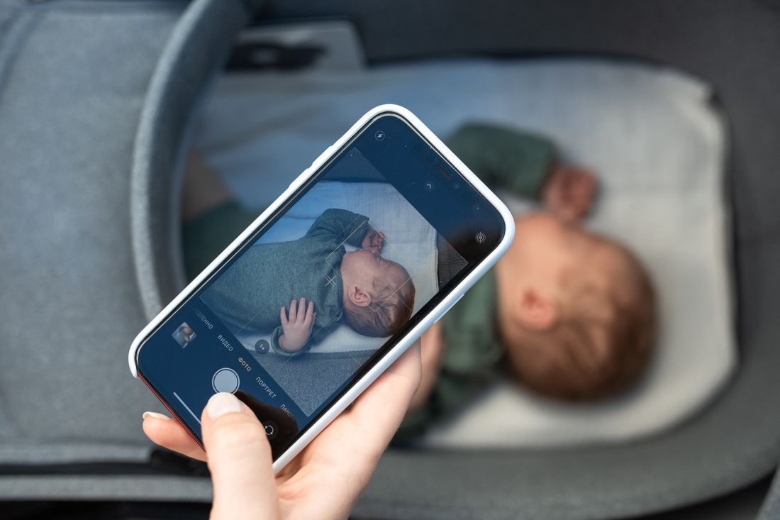 A newborn baby sleeping in a bassinet