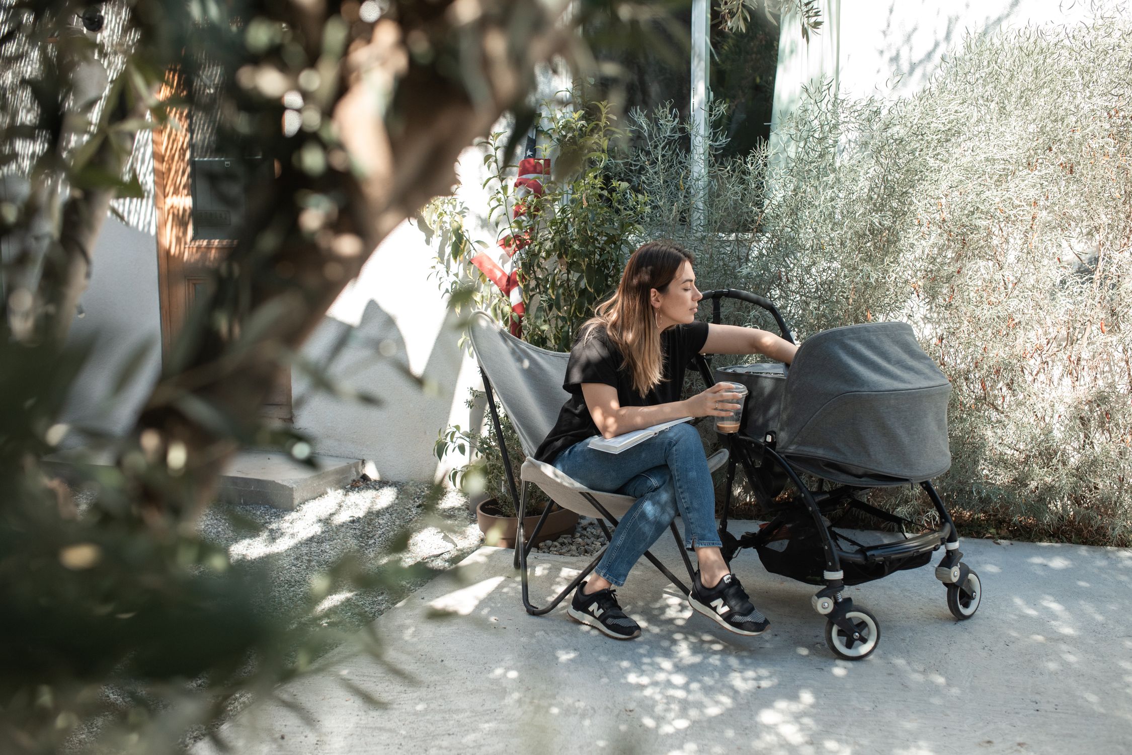 Woman in Black Tank Top and Blue Denim Jeans Sitting on Black Chair ...