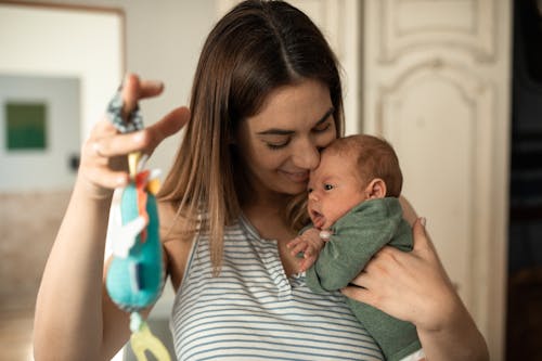 Free A Happy Woman Playing with her Baby Stock Photo