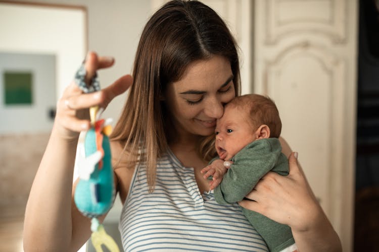 A Happy Woman Playing With Her Baby