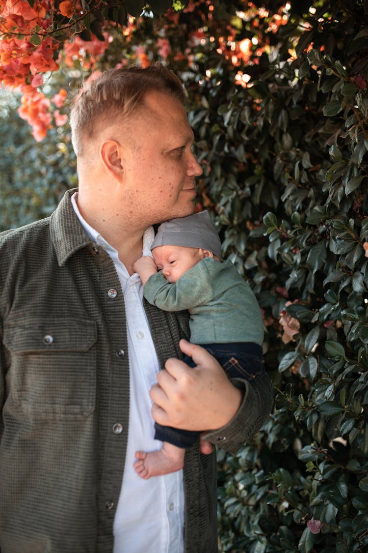 A Man Carrying A Baby