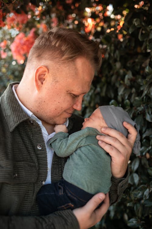 Free A Man Carrying a Baby Stock Photo