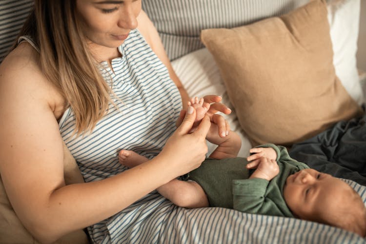 Baby Lying On Her Mother's Lap